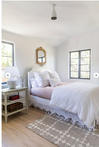 A white bedroom with a twin bed in lavender and white