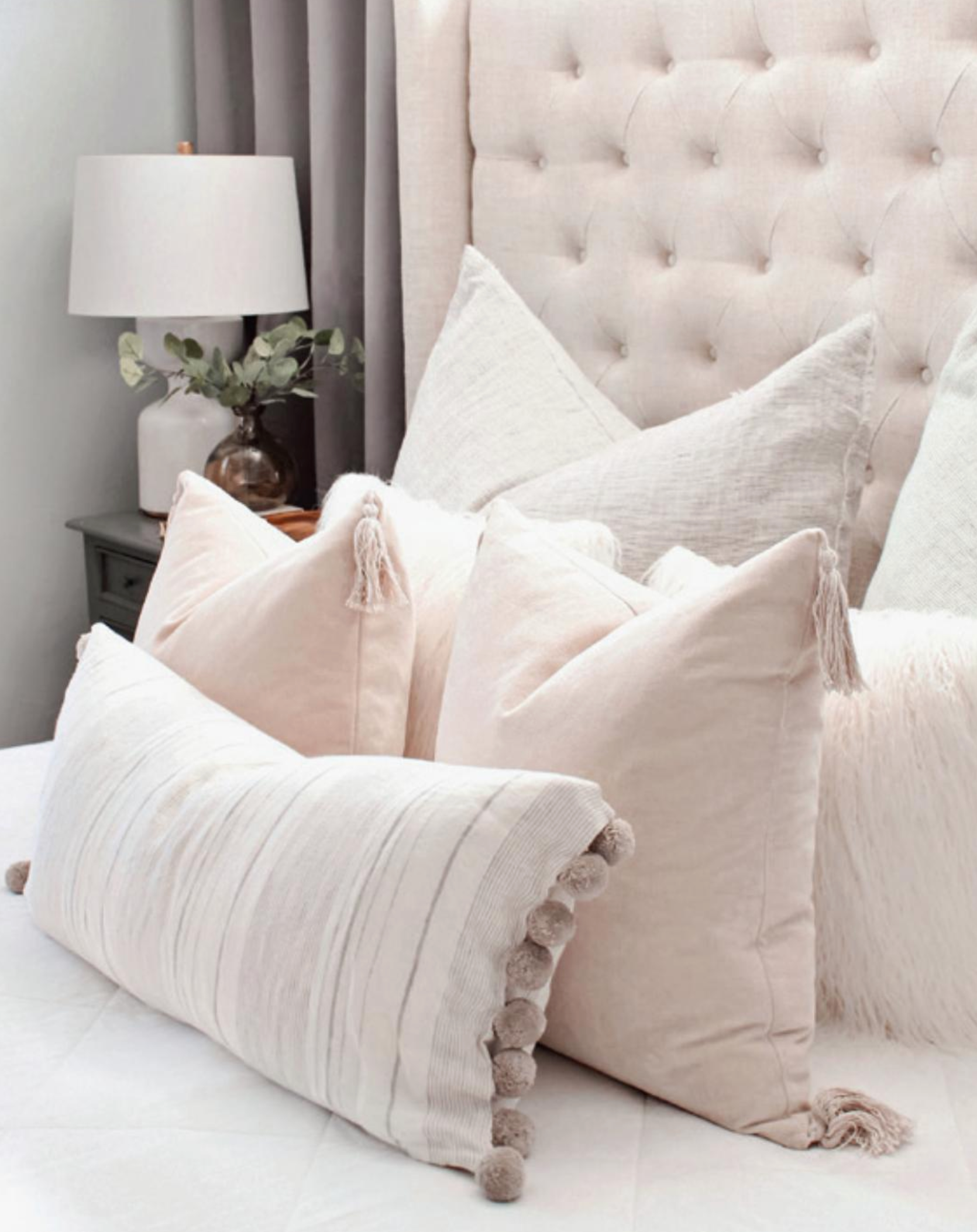 decorative pillows on a bed