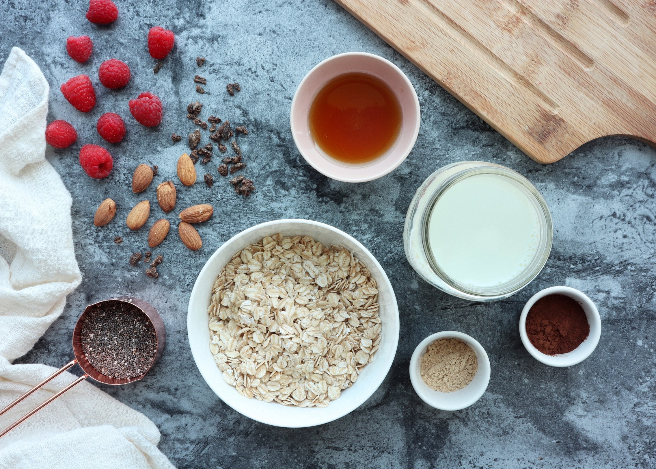 Maca Overnight Oats Topped with Cocoa, Almonds and Raspberries