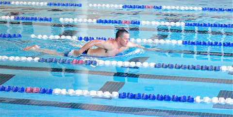 Surfinshape founder using workout board in lap pool training for surf trip