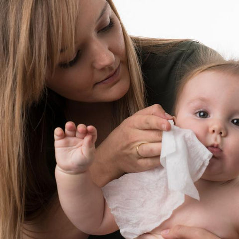 Mom using wipes on a baby