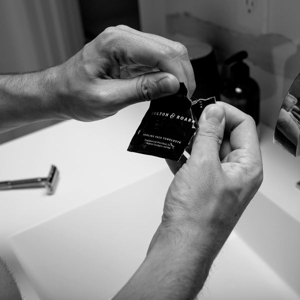 Image of hands opening an aftershave cloth