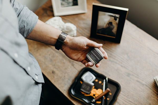 Image of hand holding a Fulton & Roark Hatteras solid fragrance/cologne