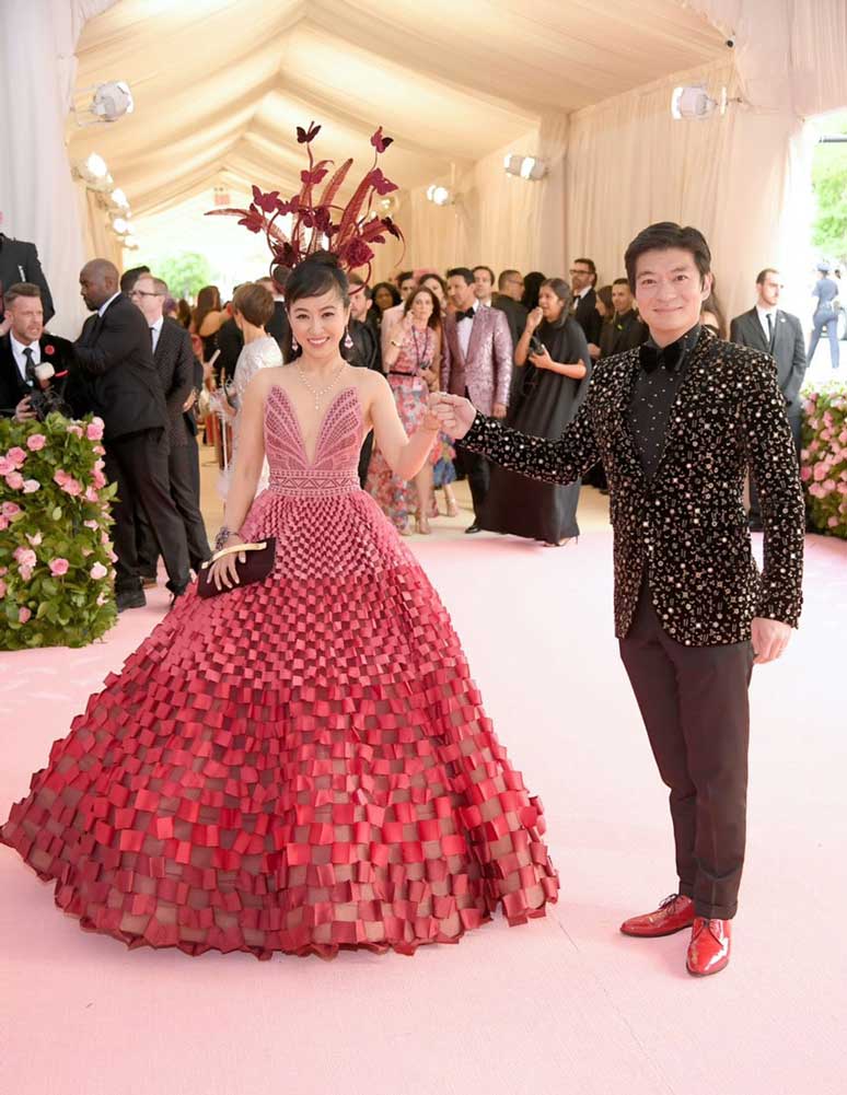 Coral and husband posing on pink carpet