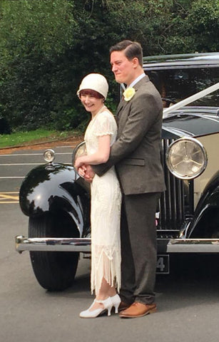 The bride and groom wearing their 1920s outfits, bride in Anna Chocola cloche hat
