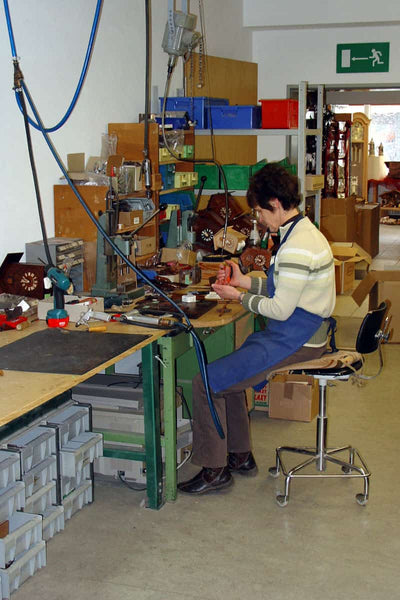 Cuckoo Collections presents to you August Schwers workshop with a lady assembling the clock frames. 