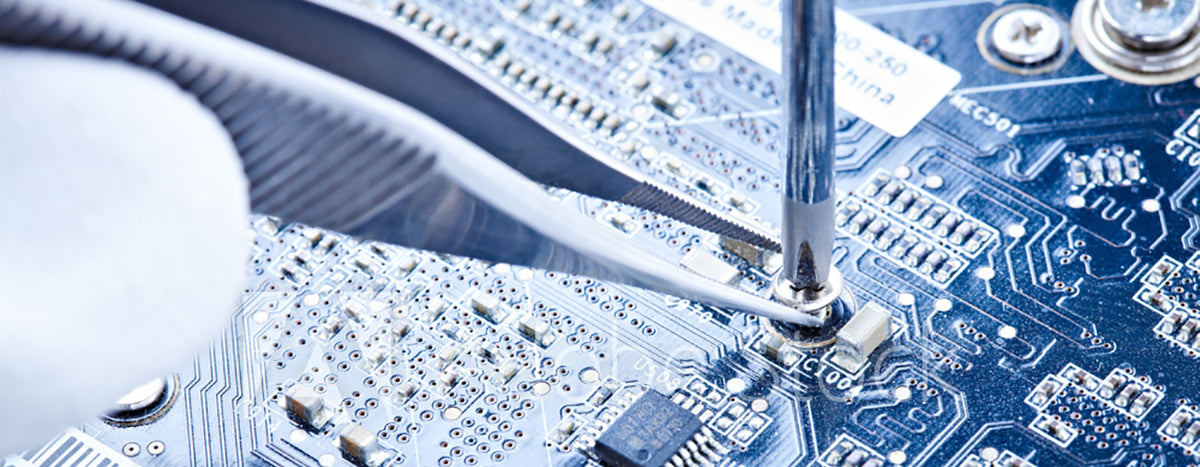 tweezers and scredriver on a circuit board