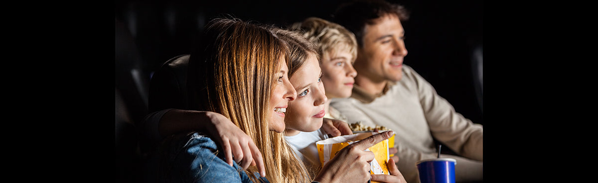 Family watching a movie at home