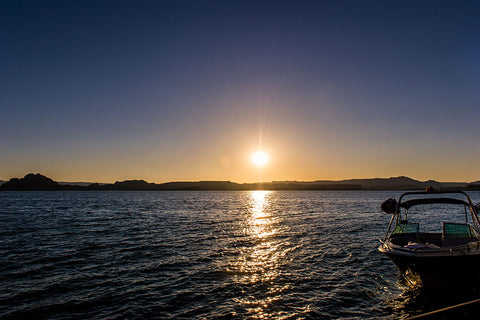 Wakeboard Boat on the Water with the Sun Setting
