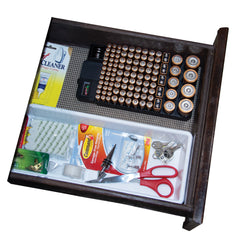 White background featuring black junk drawer with items: scissors, keys, items to hang photos and black battery storage case filled with batteries.