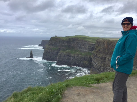 Moher cliffs, hiker wearing Wild Kiwi clothing storm jacket from wildkiwiclothing.co.nz