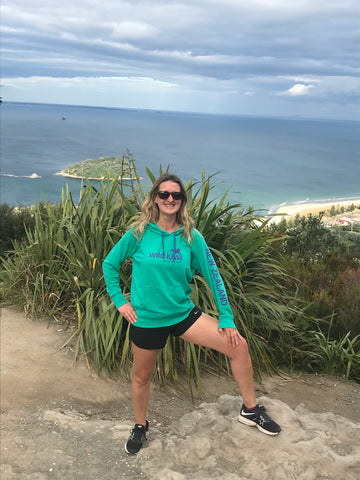 Jogger at the top of Mount Maunganui, New Zealand, wearing Wild Kiwi clothing lightweight hoodie.