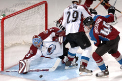 NHL hockey game player taking a shot on goal