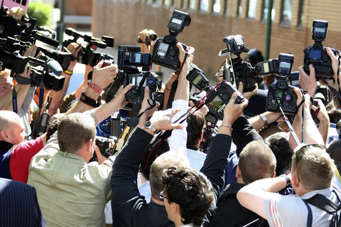 photographers trying to get the best picture during a media scrum