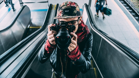 photographer taking a picture on an escalator