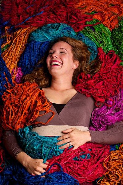 woman laying over yarn