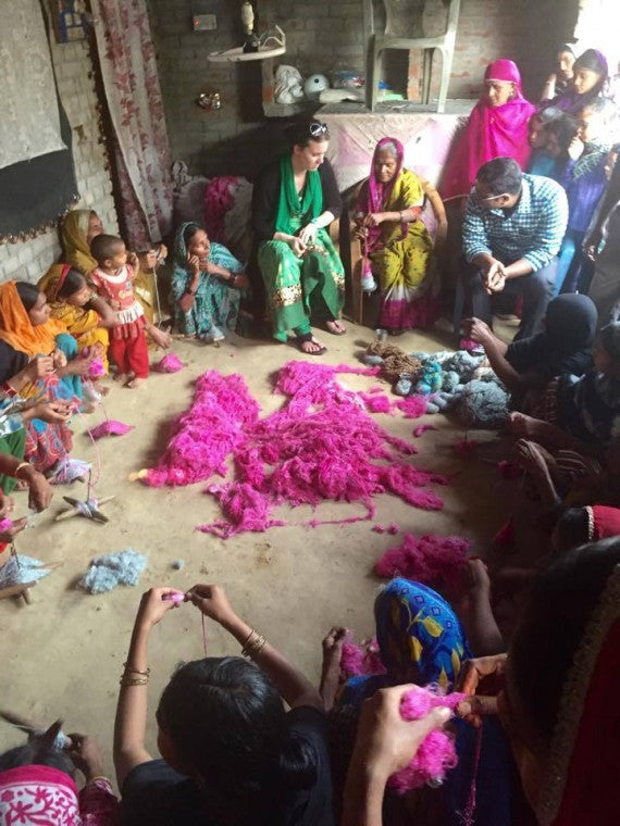 Nicole in India with artisans making yarn.
