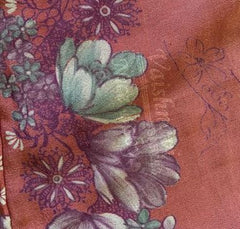A pink floral skirt with a stamp on the fabric. These stamps are common and can be easily removed with rubbing alcohol. 
