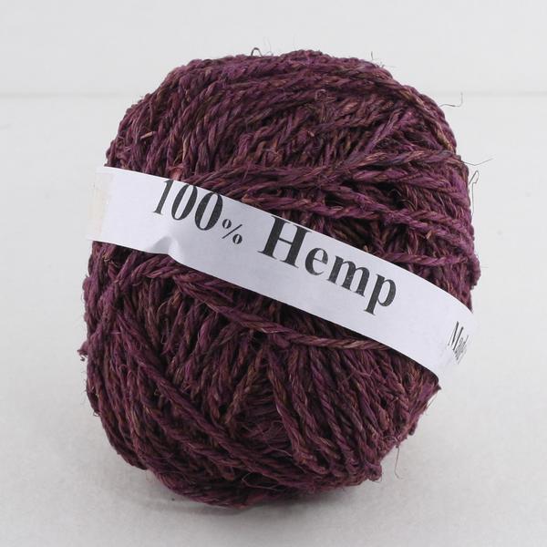 Purple ball of hemp yarn with a white label that reads '100% Hemp' sitting on a white background