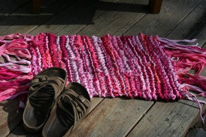 small pink yarn rug with slippers