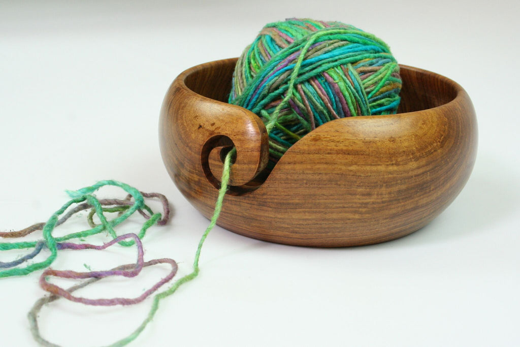 yarn bowl with yarn over a white background