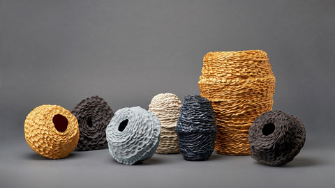 collection of textured ceramic vessels in blue, grey and gold