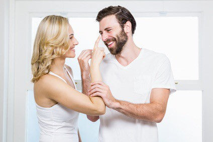 Woman applying the best mens skincare on man using Men's Botanics Products