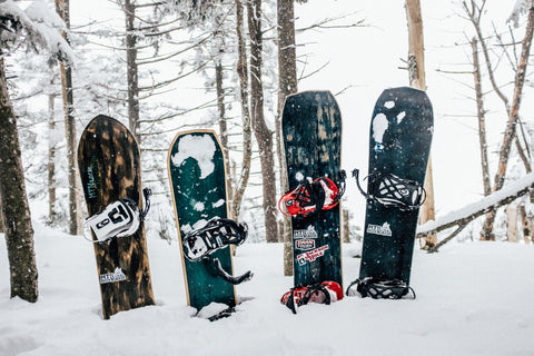 four of Max's handmade snowboards out in the snow