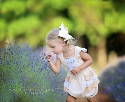 little girl smelling lavender