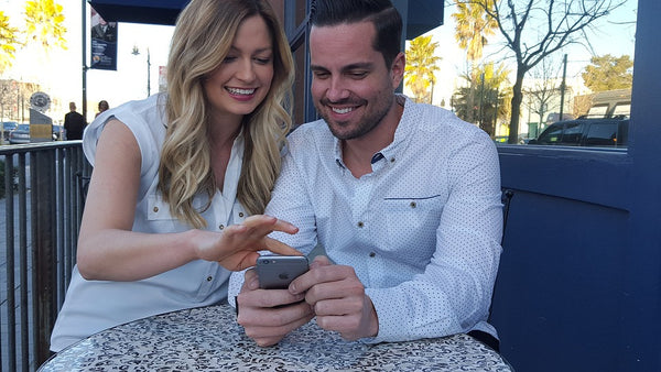 Woman sharing her photos on phone with a man