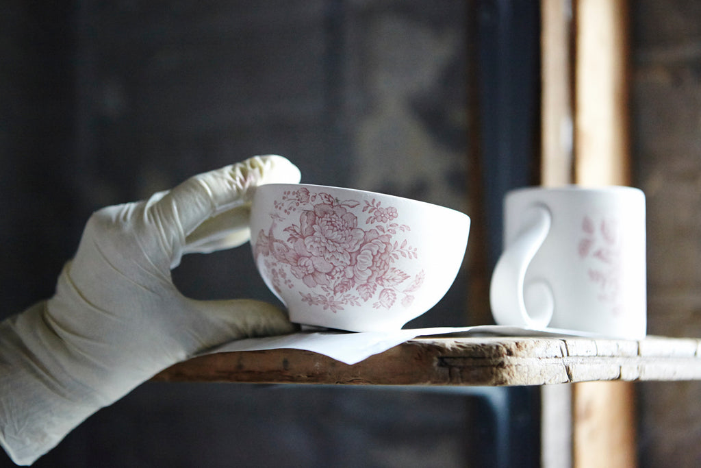 A Pink Asiatic Pheasants Rice Bowl being placed on a shelf ready for firing