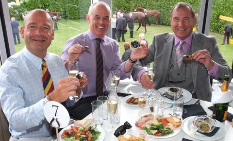 Three manly friends enjoying some caviar and champagne