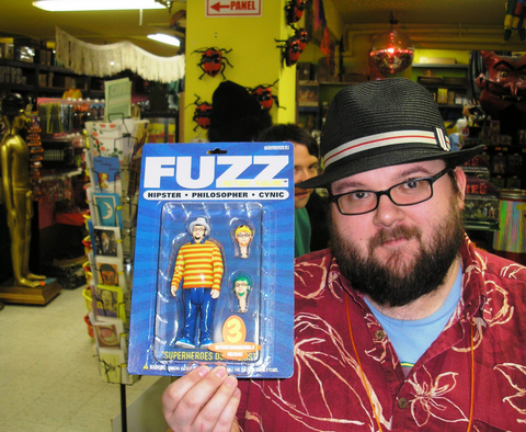 Fuzz holding a fuzz action figure in Archie McPhee store in wallingford