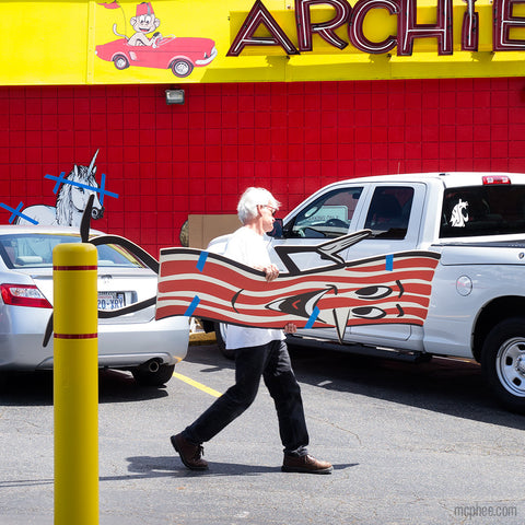 Mr. Baco being carried across Archie McPhee parking lot