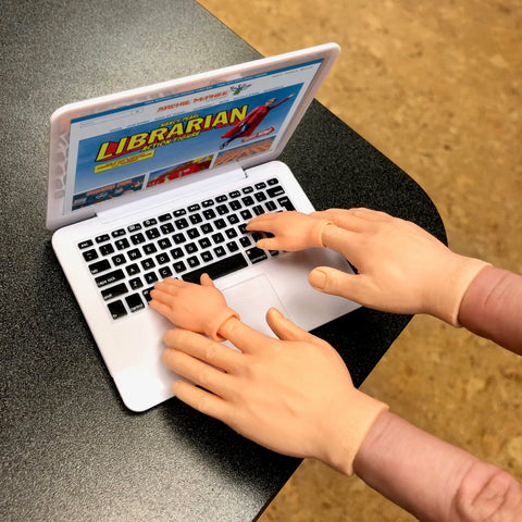 Finger Hands on tiny laptop
