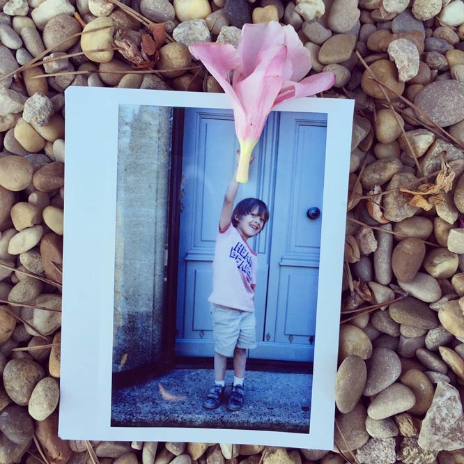 Polaroid Picture of Child Holding a Flower