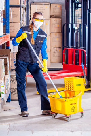 Warehouse cleaning personal with mop and mask