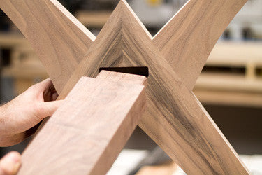Mortise and tenon joint being inserted for walnut dining table 