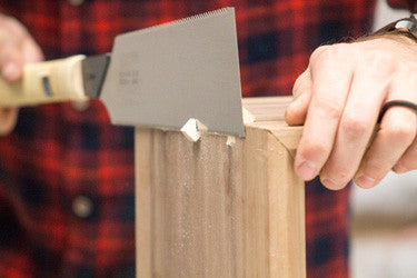 hand sawing dovetail splines on waterfall edge