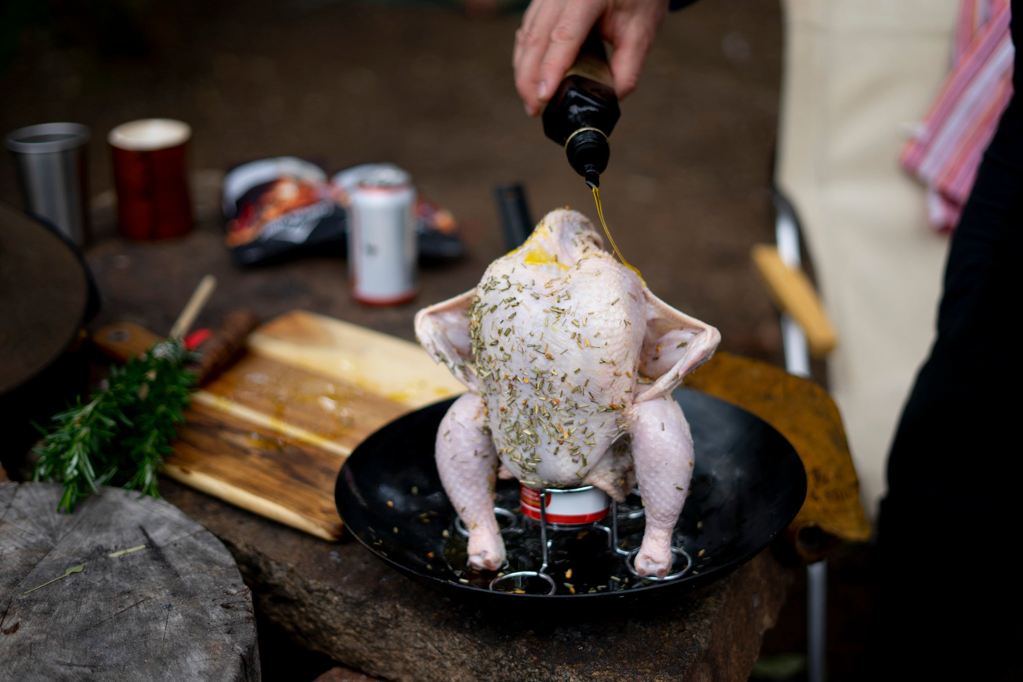 Once your beer can chicken is sitting up like Jackie give it one last splash with oil. Place the wings hands on hips so the inside of the wing cooks and crisps up. 