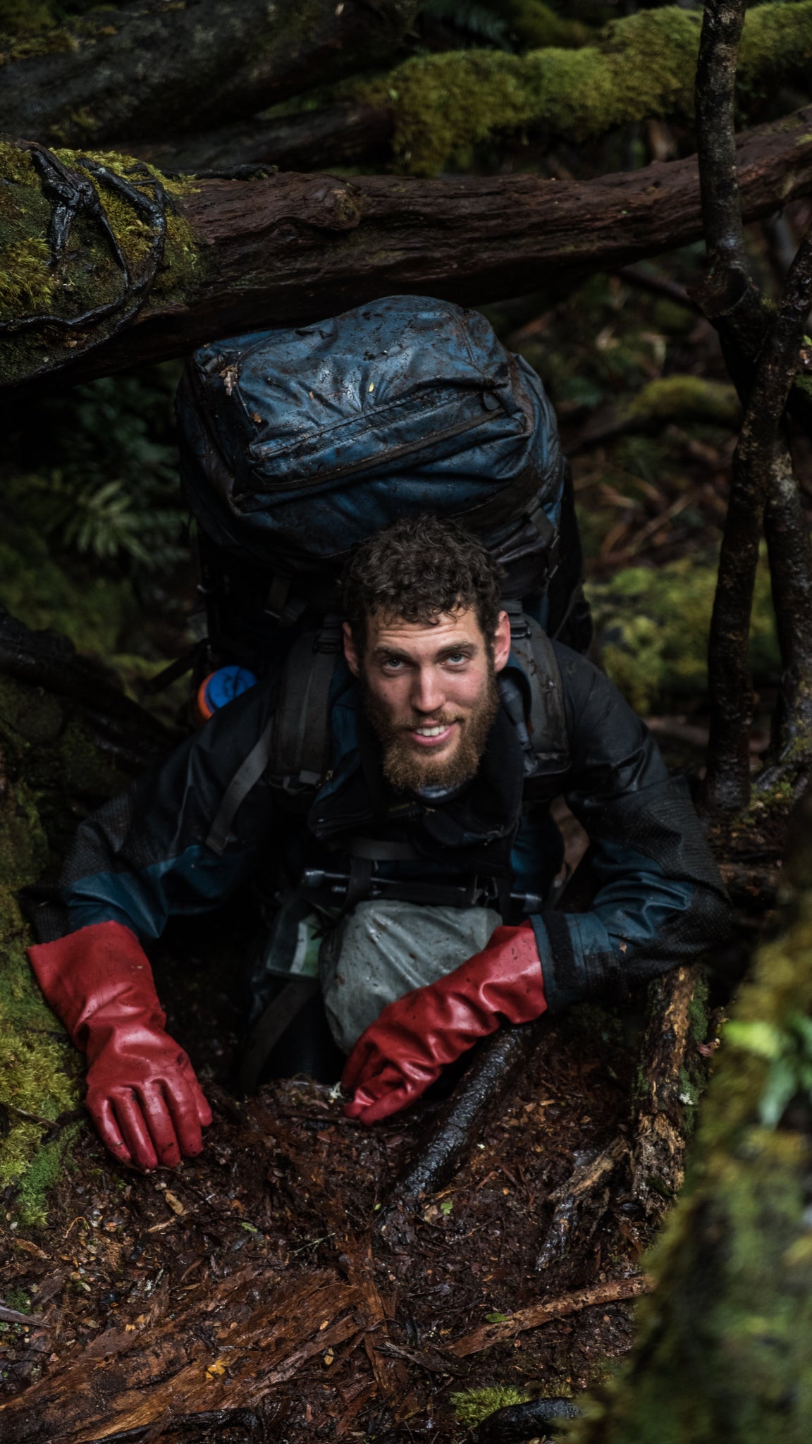 Andy Szollosi climbing in Tasmania into know where carrying a 45 kilo pack. This photo from one of TASPARKS trails in the wilderness of Tasmania when filming Winter on the Blade. Hiking in Tasmania is a passion of Andy's and carrying in  his camera gear to capture these rugged landscapes and epic adventures is what we love about Andy Szollosi. Winter on the Blade is one of the most epic films following a crew of climbers in Tasmania tackling Federation Peak. This film has been aired around the world through the Banff Mountain Film Festival 2018.