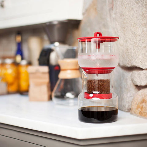 Cold brew system on a kitchen bench, coffee grounds dripping through