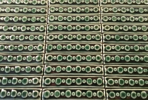 handmade tiles, one inches by six inches, green glaze, circle pattern
