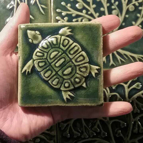 handmade tile depicting a turtle, green glaze
