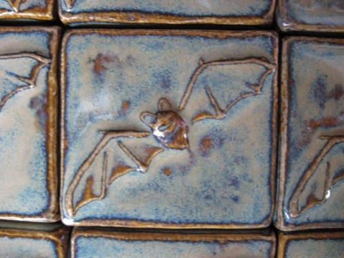 close up of handmade ceramic bat tile