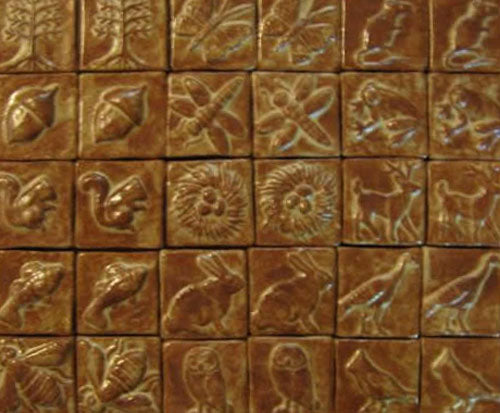 handmade tiles with nature theme and cinnamon glaze"