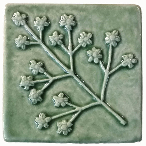 delicate floret four inch by four inch handmade tile in spearmint glaze