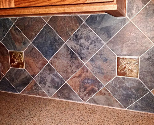 handmade tiles mixed with slate tiles in a kitchen backsplash