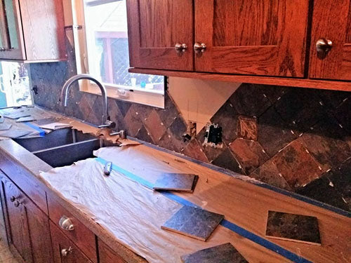 installing handmade tiles in a kitchen