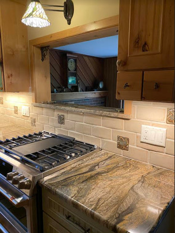 handmade maple leaf tiles installed in a kitchen